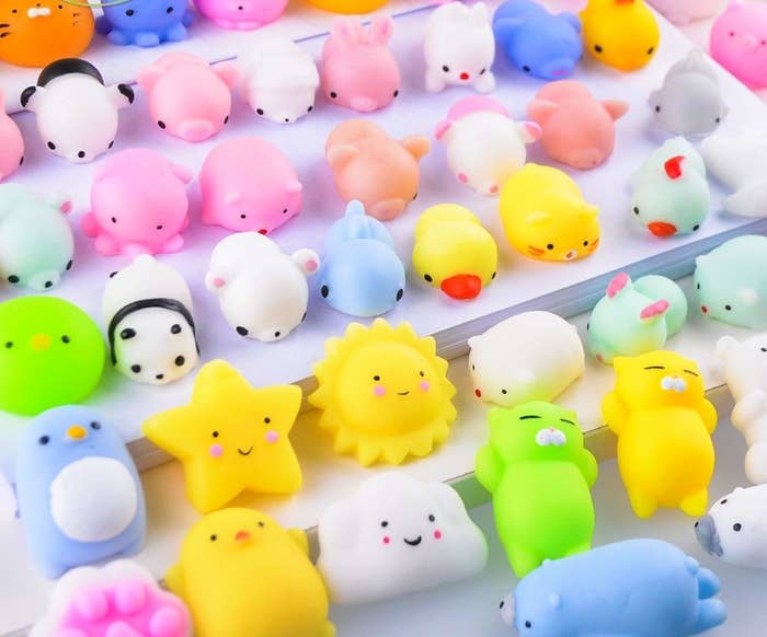 A collection of squishy-looking toys that are each about an inch long. Some shapes include a lion, star, cloud, penguin, and duck