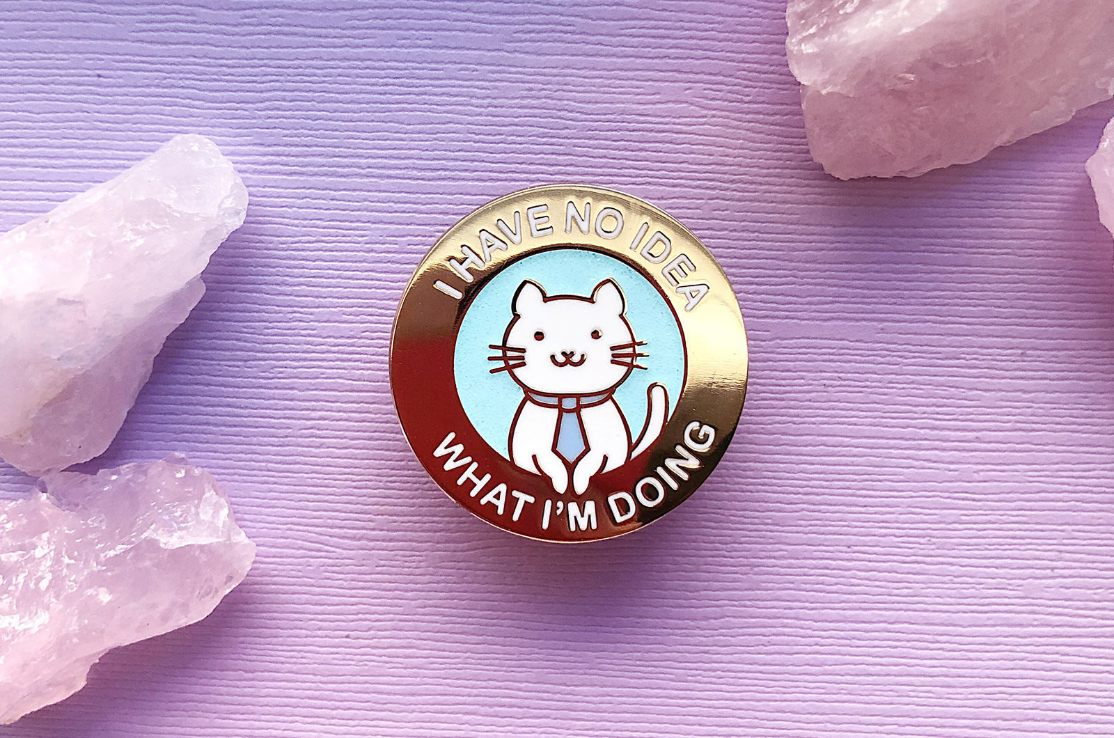 A pin with a cat wearing a tie that says &quot;I have no idea what I&#x27;m doing&quot; 