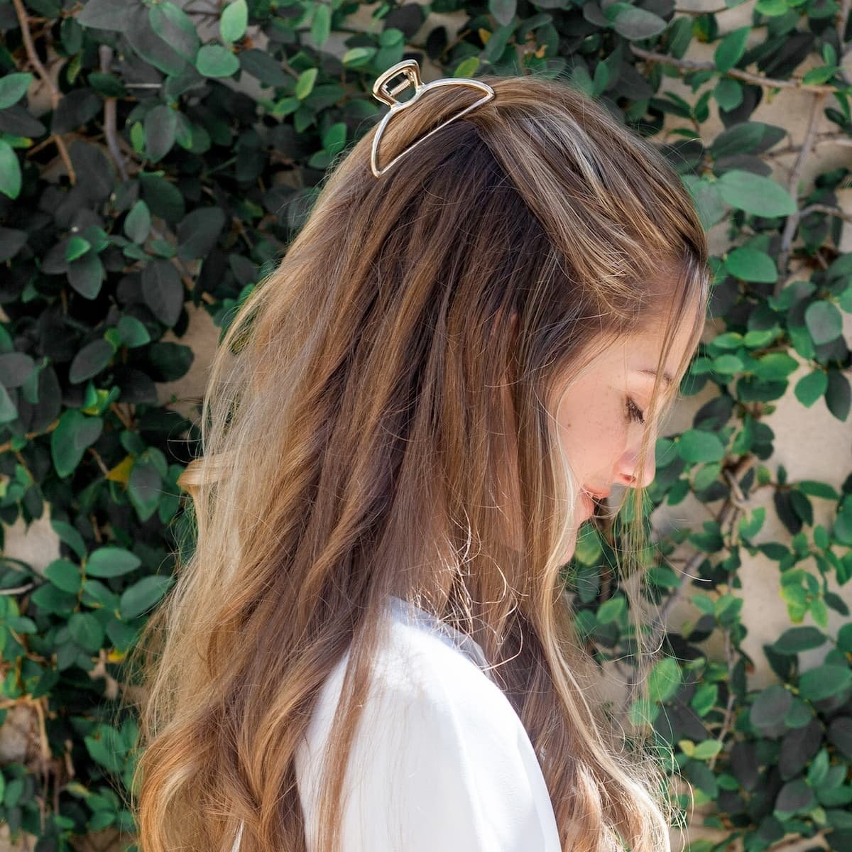 A person with long hair and a clip at the top of their head