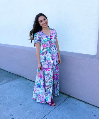 reviewer wearing short-sleeve, button front maxi in white and colorful floral print