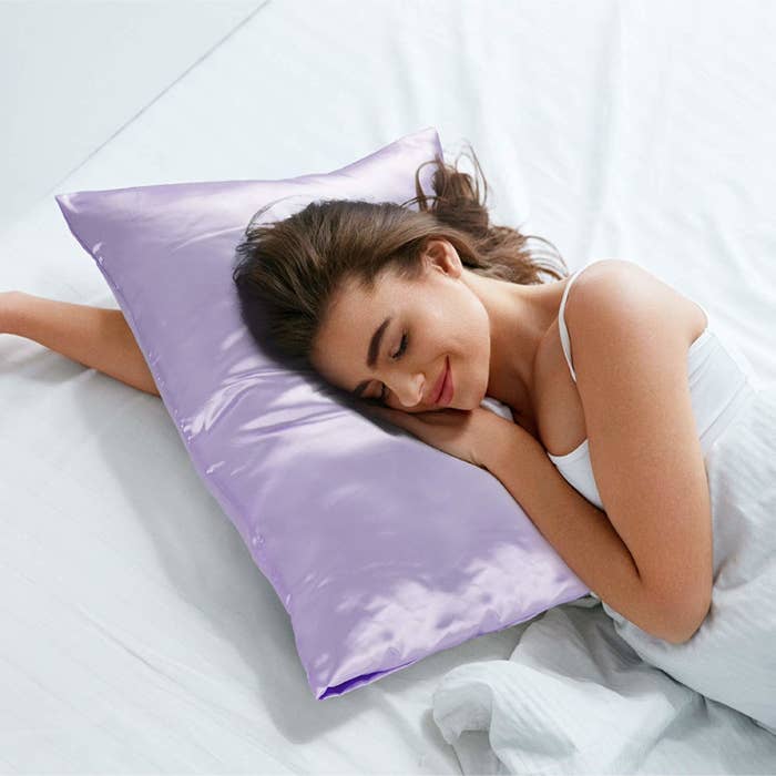 A model sleeping on the shiny lavender pillowcase