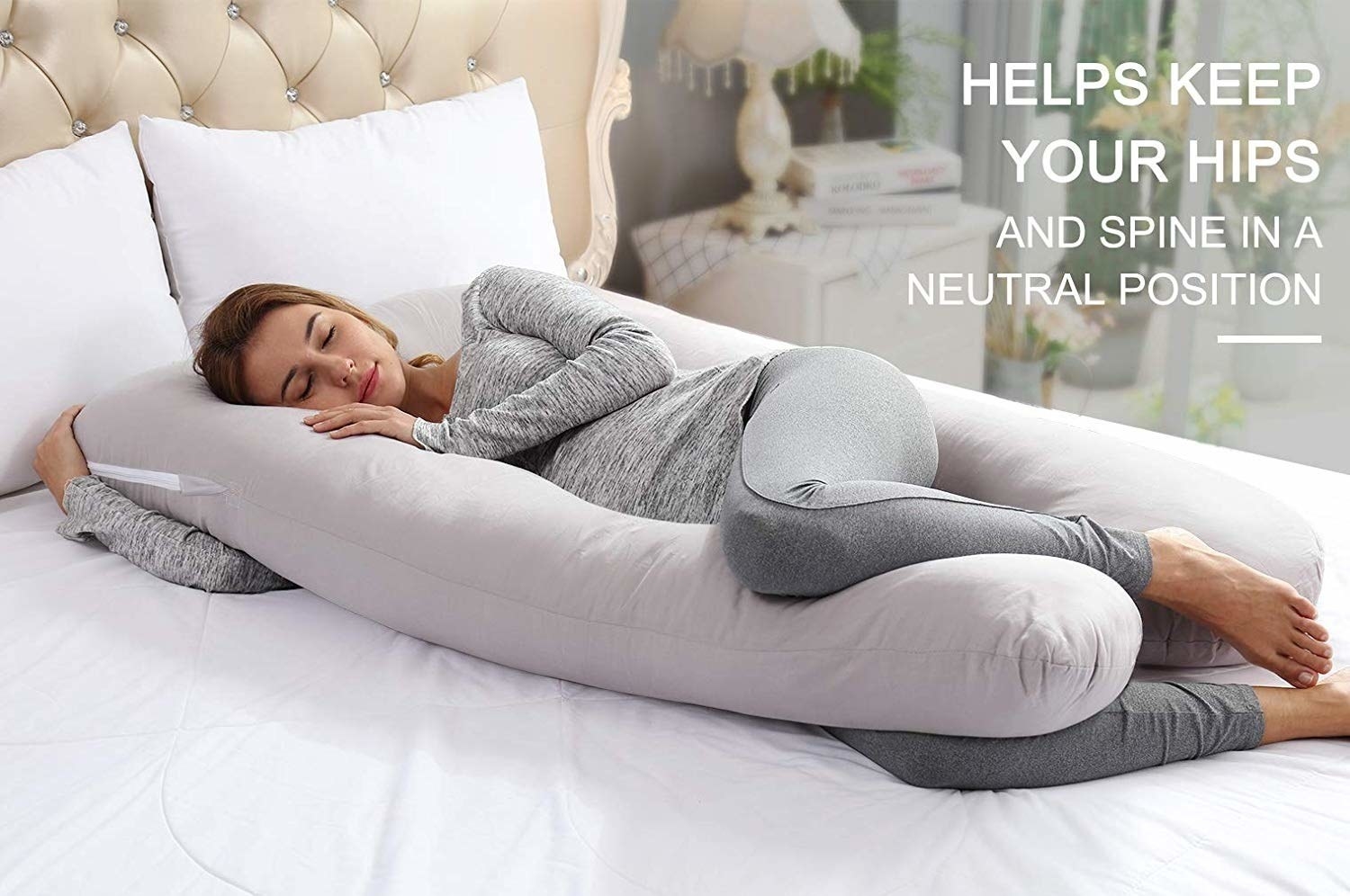 A model cuddling the pillow with text that reads &quot;Helps keep your hips and spine in a neutral position&quot;