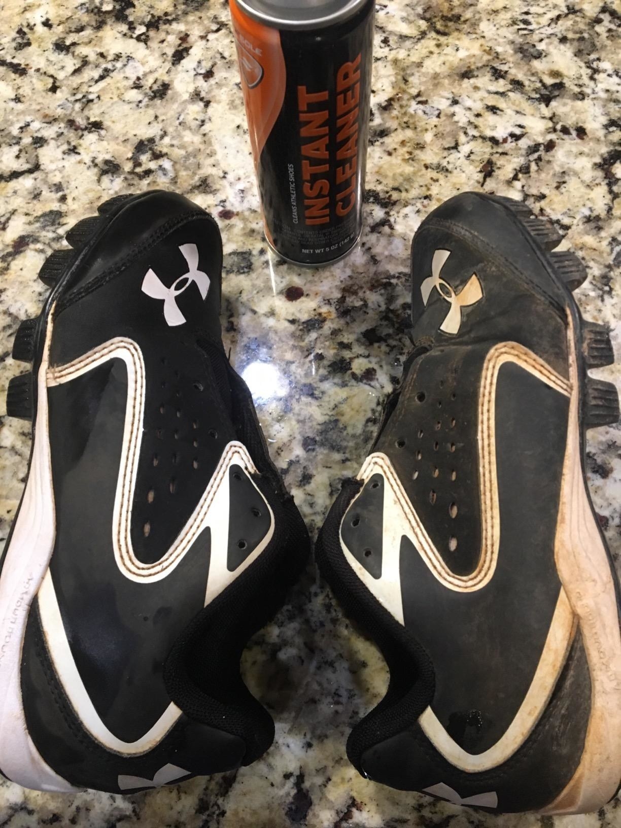 reviewer&#x27;s white and black cleats with one very dirty and the other cleaned