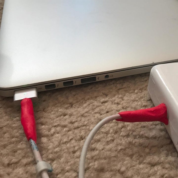 reviewer's red sugru around macbook charger cables to keep them from fraying