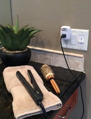 hair straightener plugged into the device