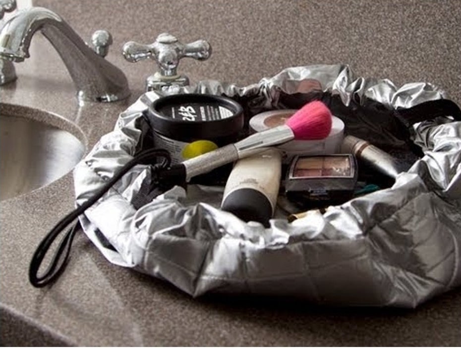 silver drawstring bag with makeup in it