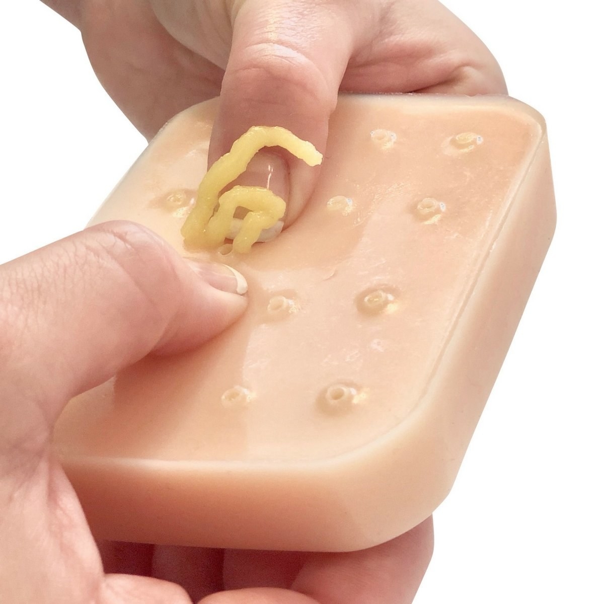 model squeezes pus out of rubbery square 