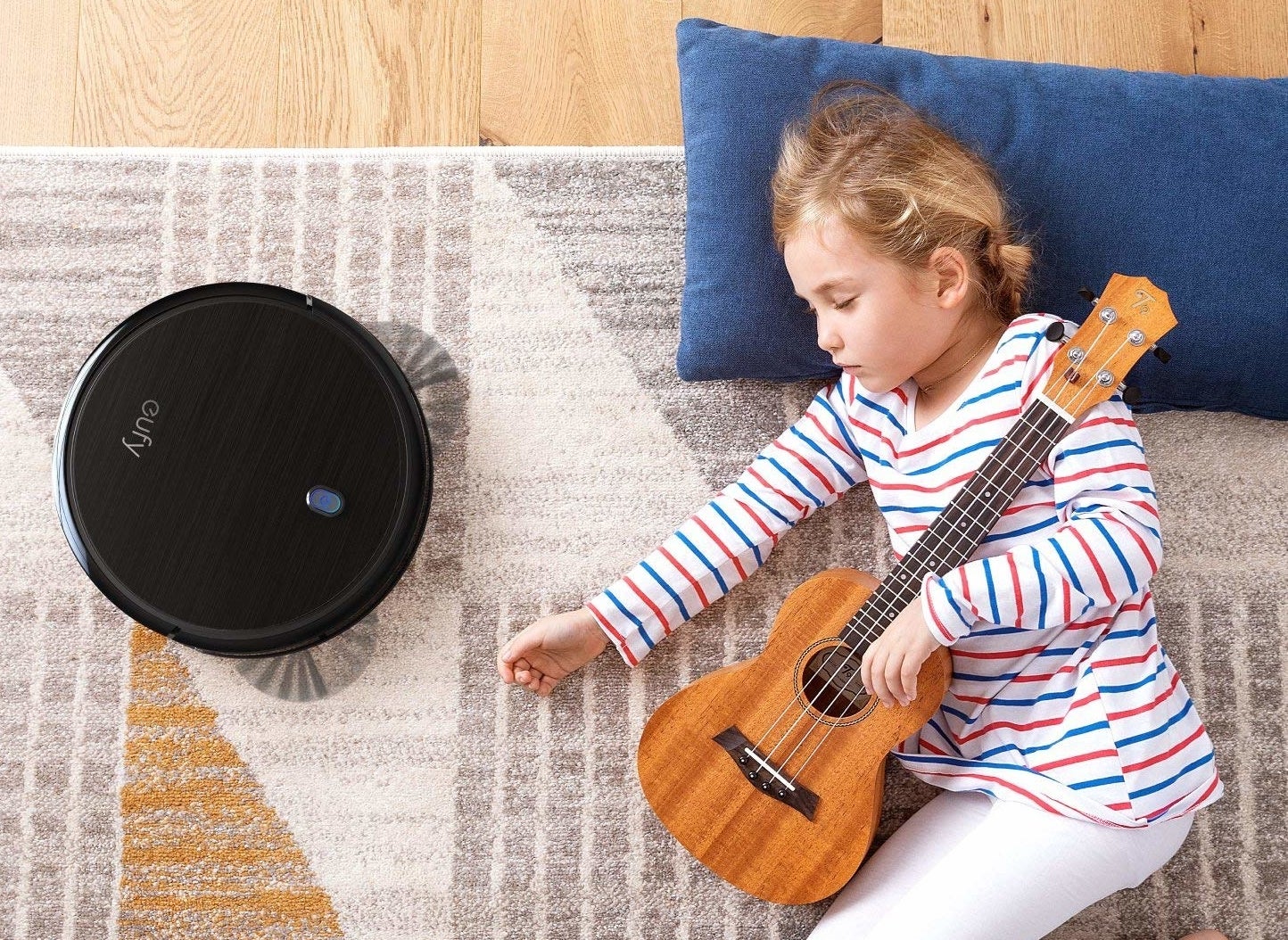 a child napping next to the vacuum