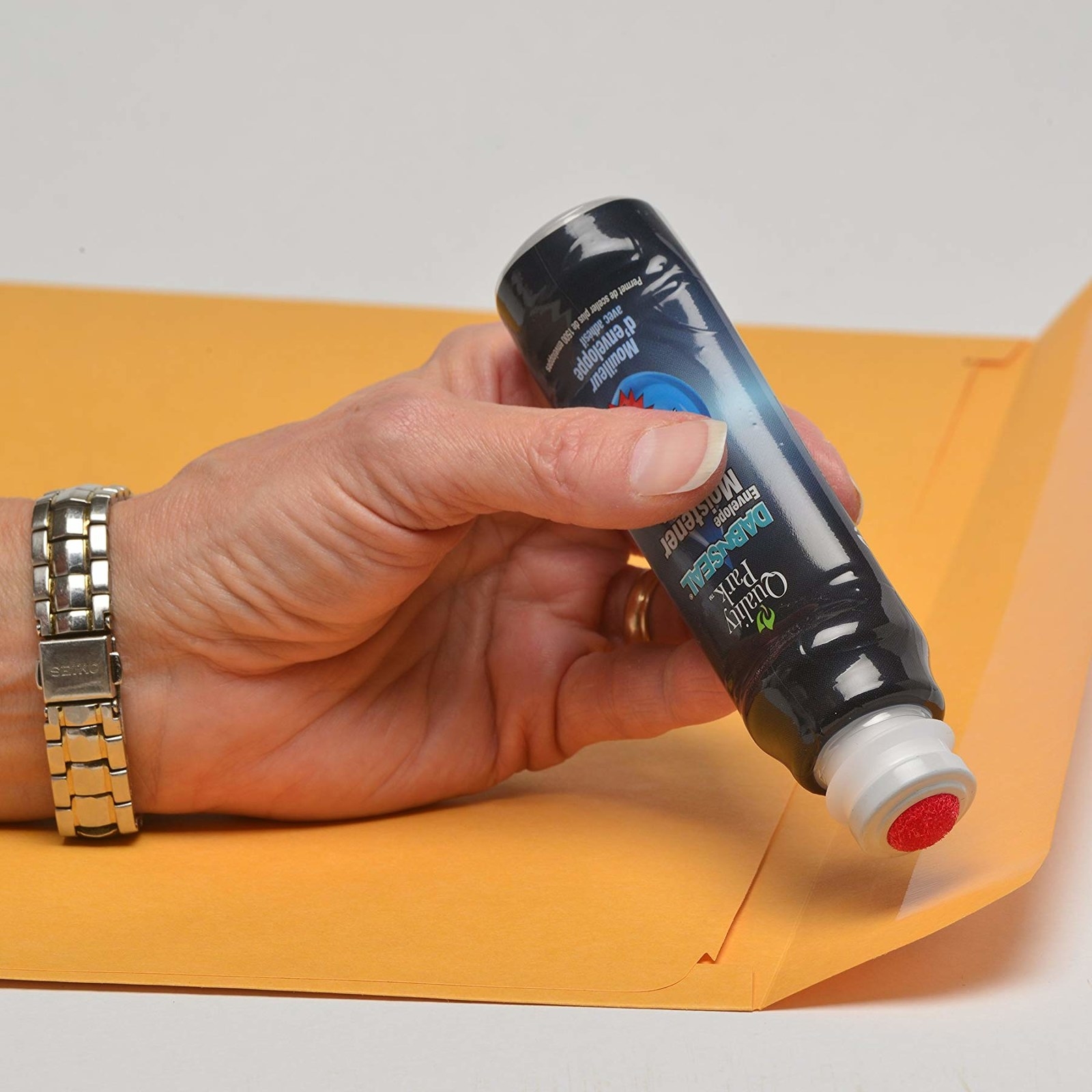 A person holding the envelope sealer