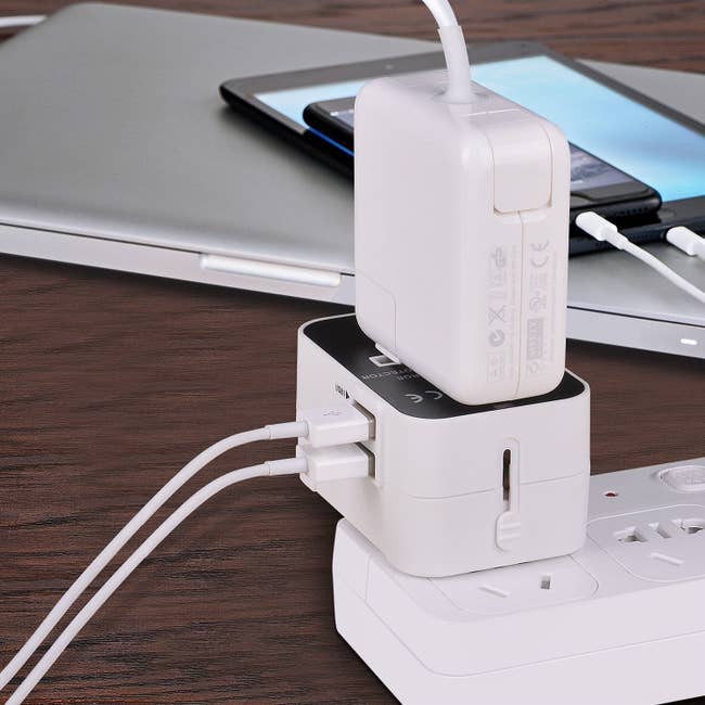 universal travel adaptor with two cords plugged into it