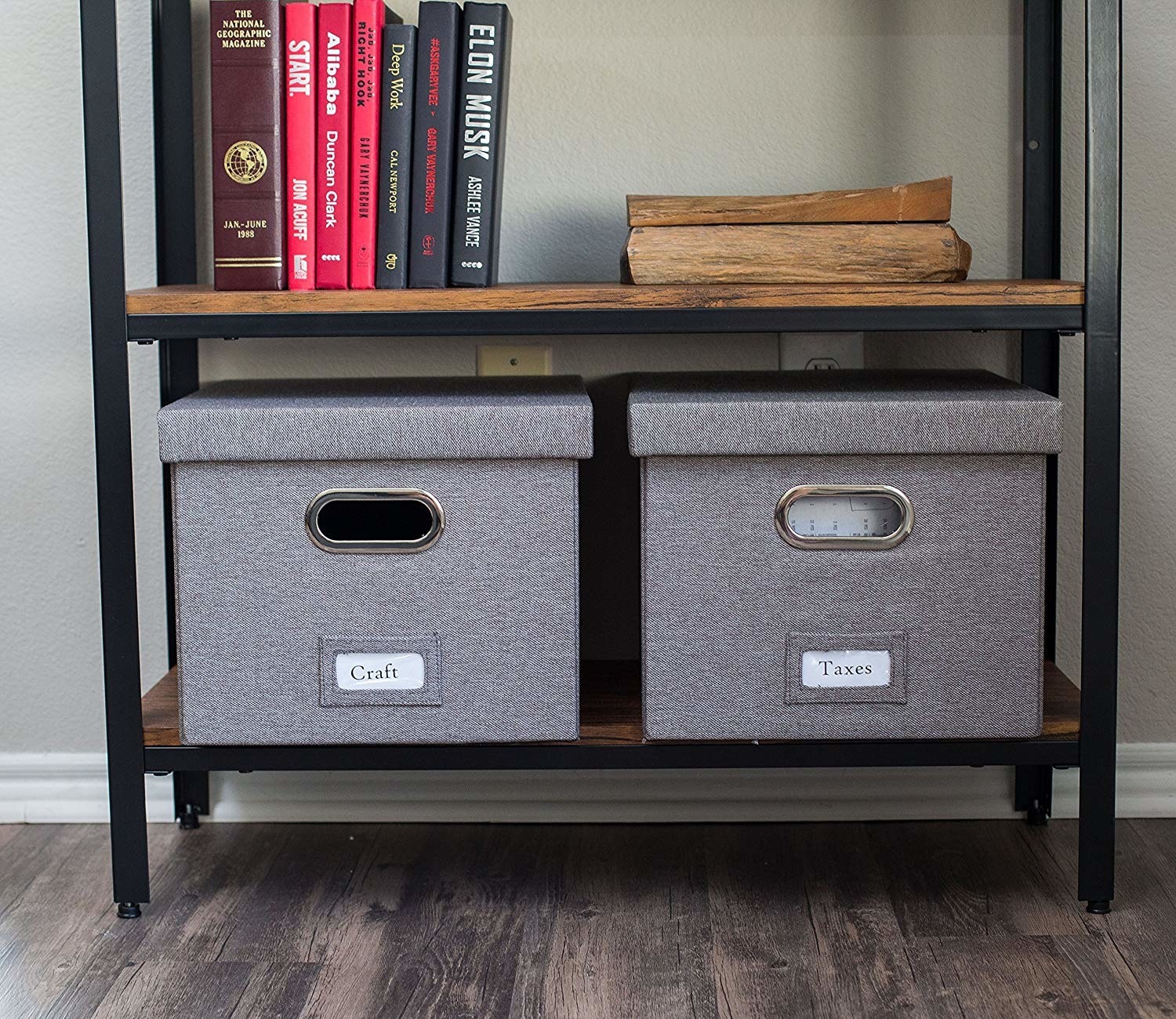 two gray fabric-covered boxes with matching lids and metal slots for handles sit on a shelf side-by-side; one is labeled &quot;craft&quot;, the other &quot;taxes&quot;