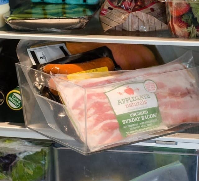 meat stored in a plastic bin in the fridge