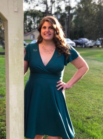 reviewer wearing the dress in green