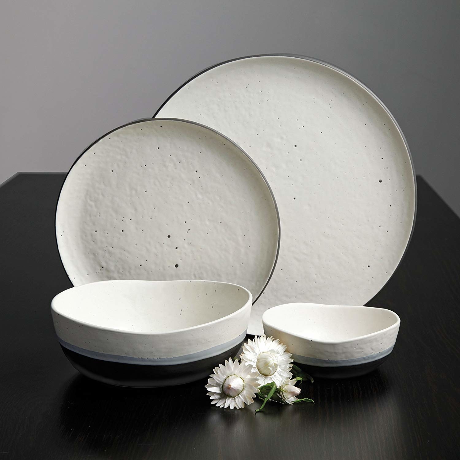 irregularly shaped bowls and plates with speckled pattern