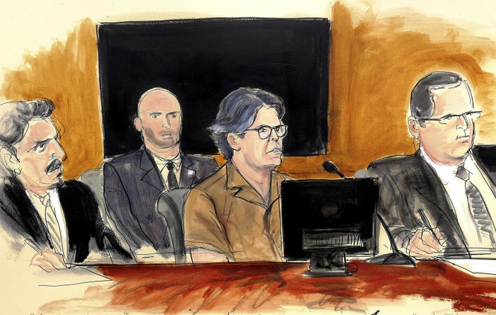 In this April 13, 2018, courtroom sketch, Keith Raniere, center, attends a hearing.