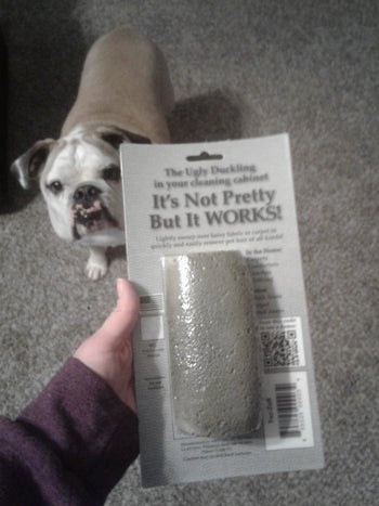reviewer holds up grey stone in packaging that says