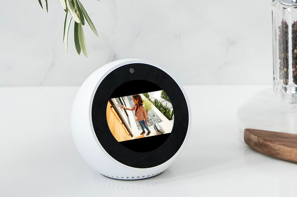 A lifestyle image of the Echo Spot displaying an image from a front door camera 