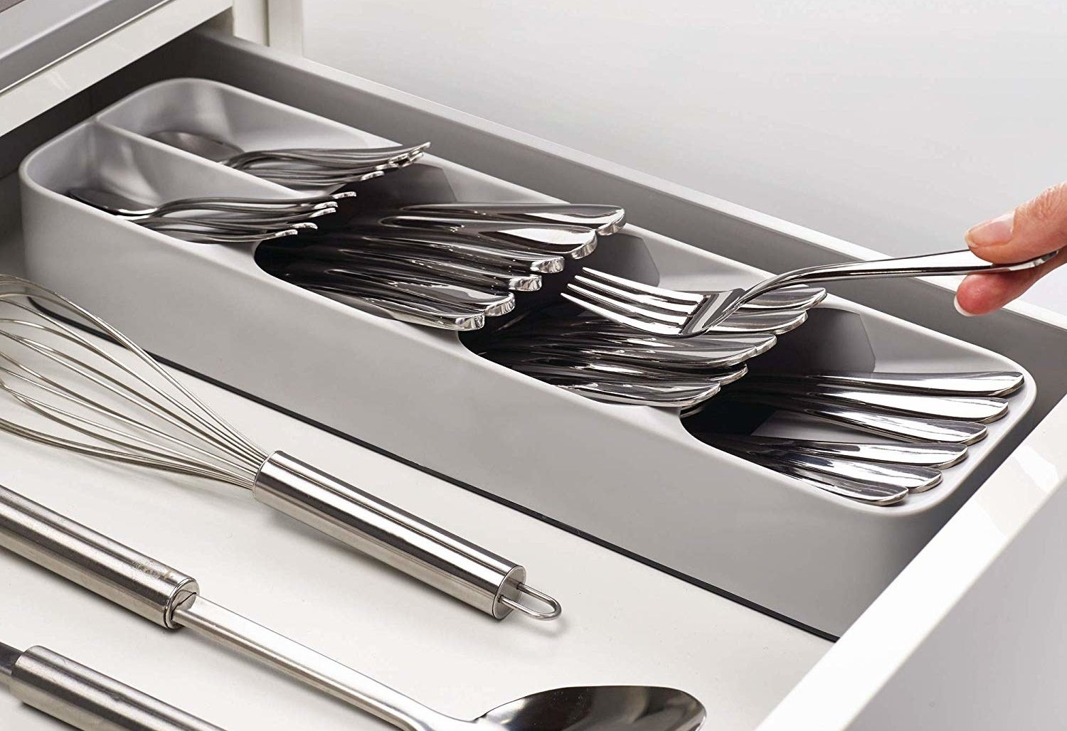 person putting a fork into the cutlery organizer