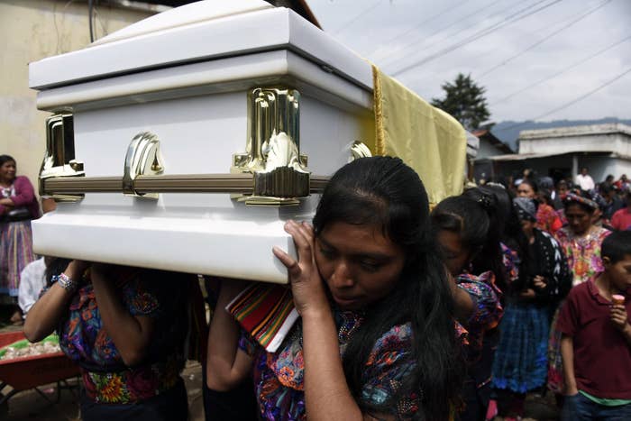Women carry the coffin of Claudia Gomez.