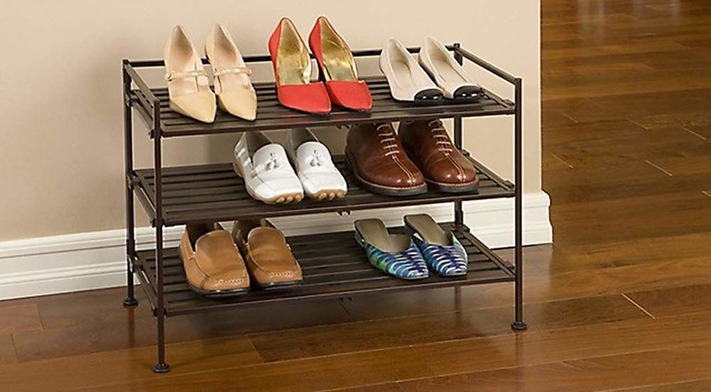 the three-tier rack holding various pairs of shoes