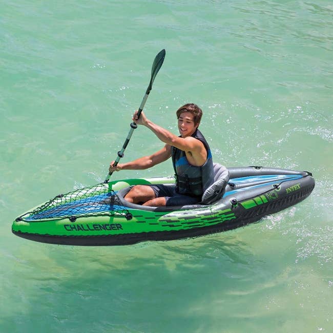 person kayaking in inflatable kayak