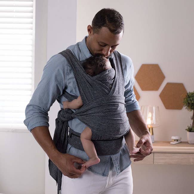 parent with child in sling wrap