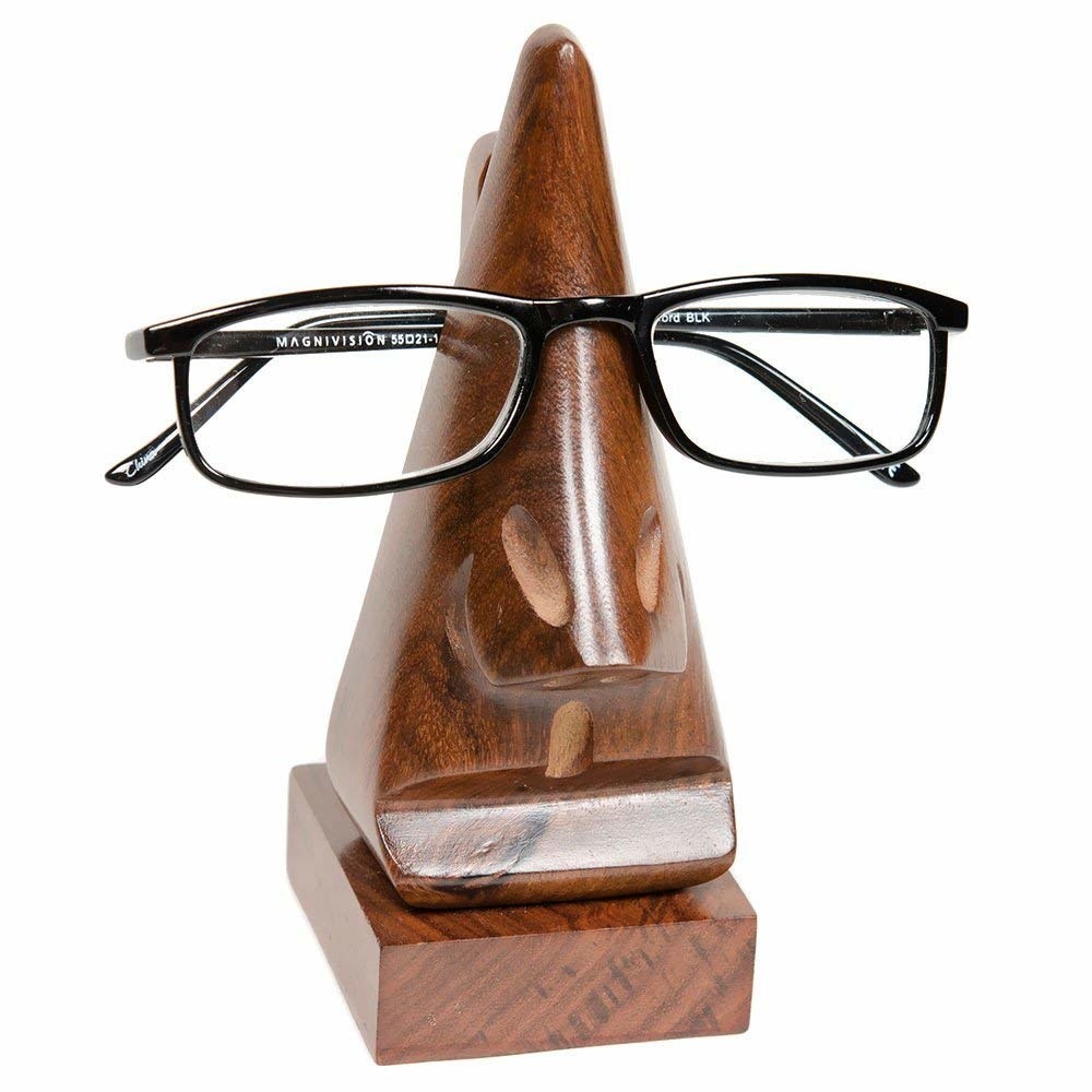 Closeup of wood eyeglass that looks like a face with glasses on it