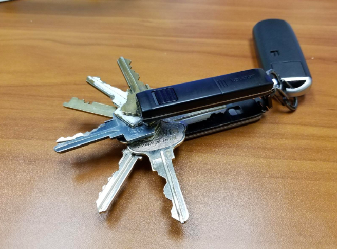 Keyport Pivot key organizer sitting on table with keys fanned out from it