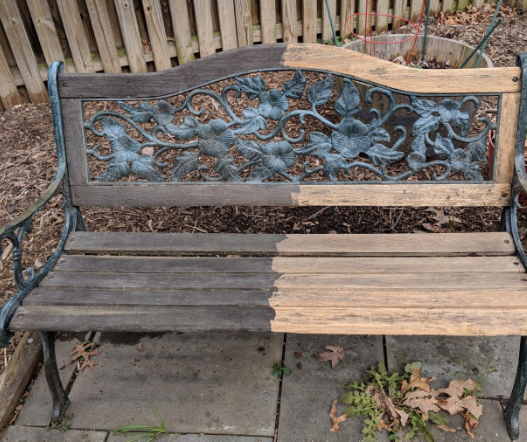 reviewer photo showing a bench that has been half cleaned with the pressure washer