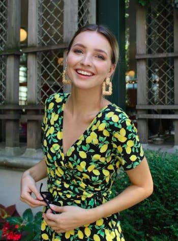 Close-up of a different reviewer wearing the dress in a lemon print.