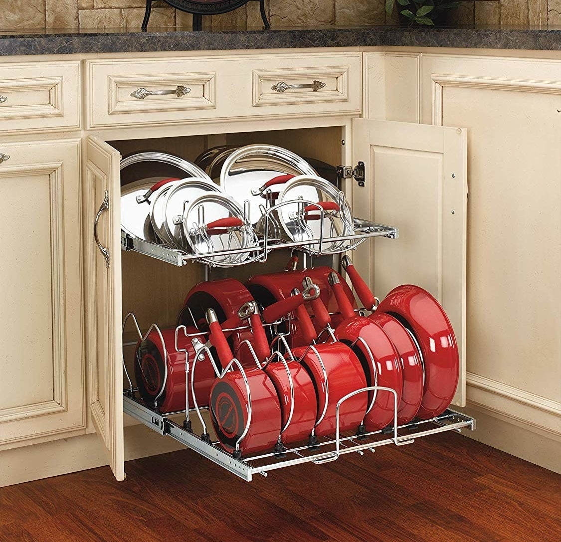 The metal organizer with nine pots/pans on the bottom and lids on top