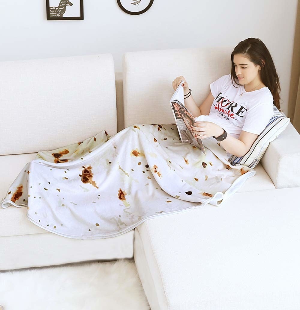woman on couch with blanket