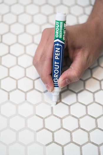 pen covering up grout with white paint