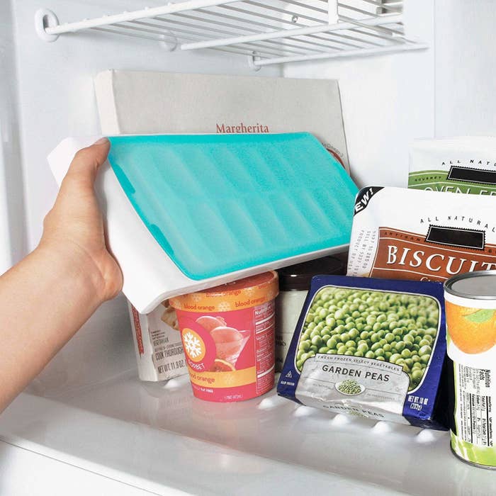 model puts ice tray with lid into freezer sideways 