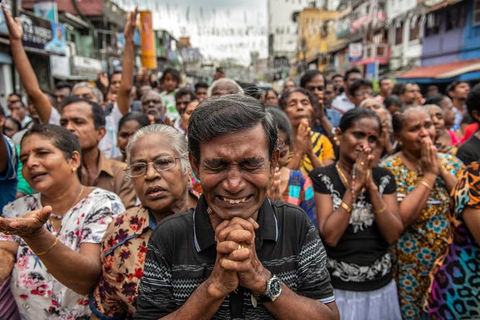 Crowds of people pray in the street near St. Anthony's Shrine in Colombo, Sri Lanka, April 28, one week after the attacks that killed nearly 300 people.