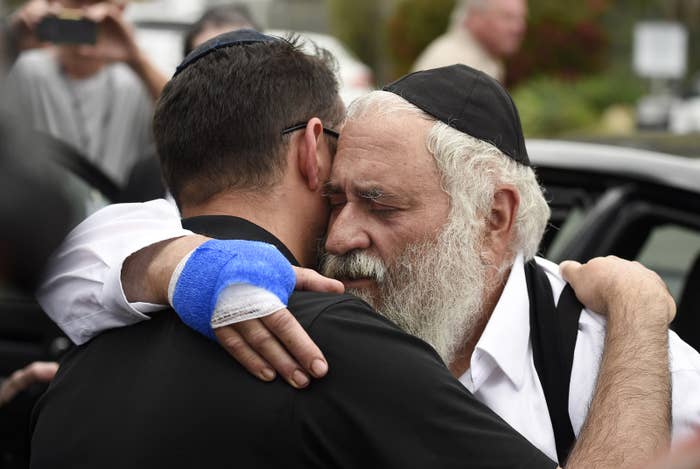Rabbi Yisroel Goldstein (right) leaves a news conference at the Chabad of Poway synagogue, April 28, in Poway, California.