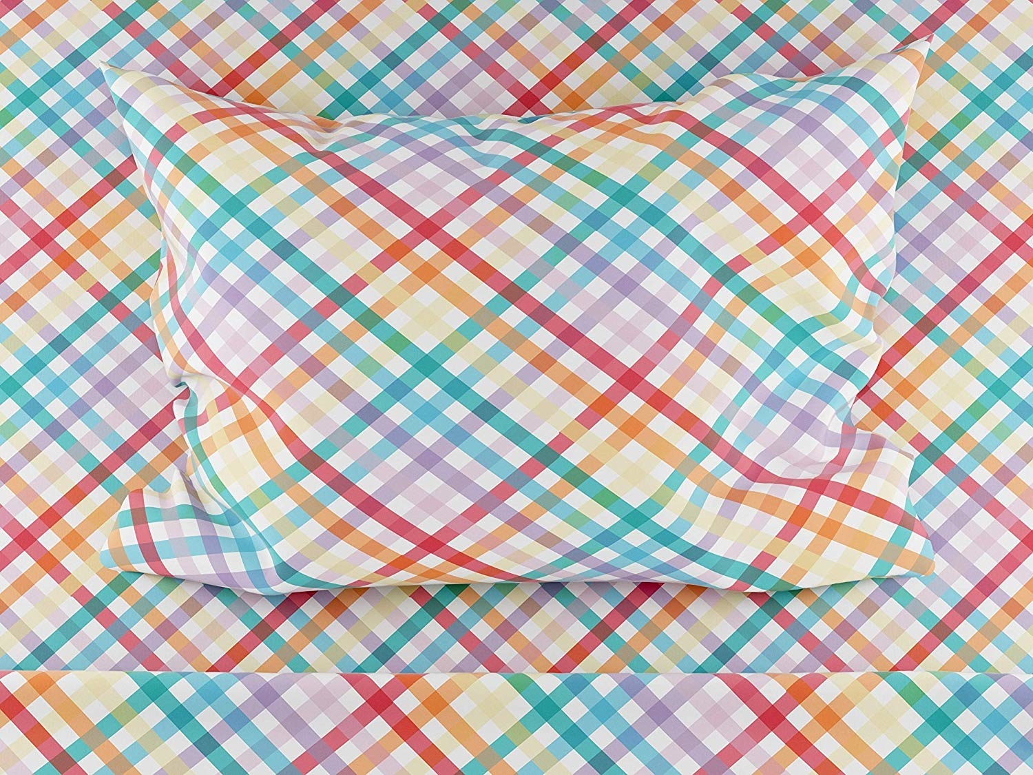 A closeup shot of multi-colored pastel checkered bedding, with sheets and a pillow case