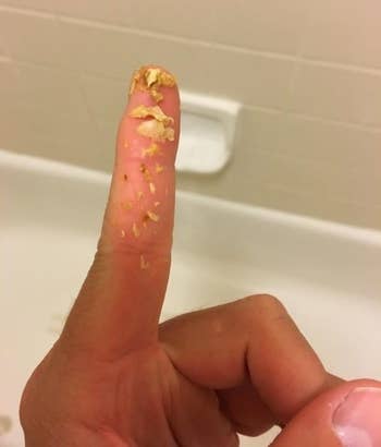 A reviewer photo of earwax on a finger
