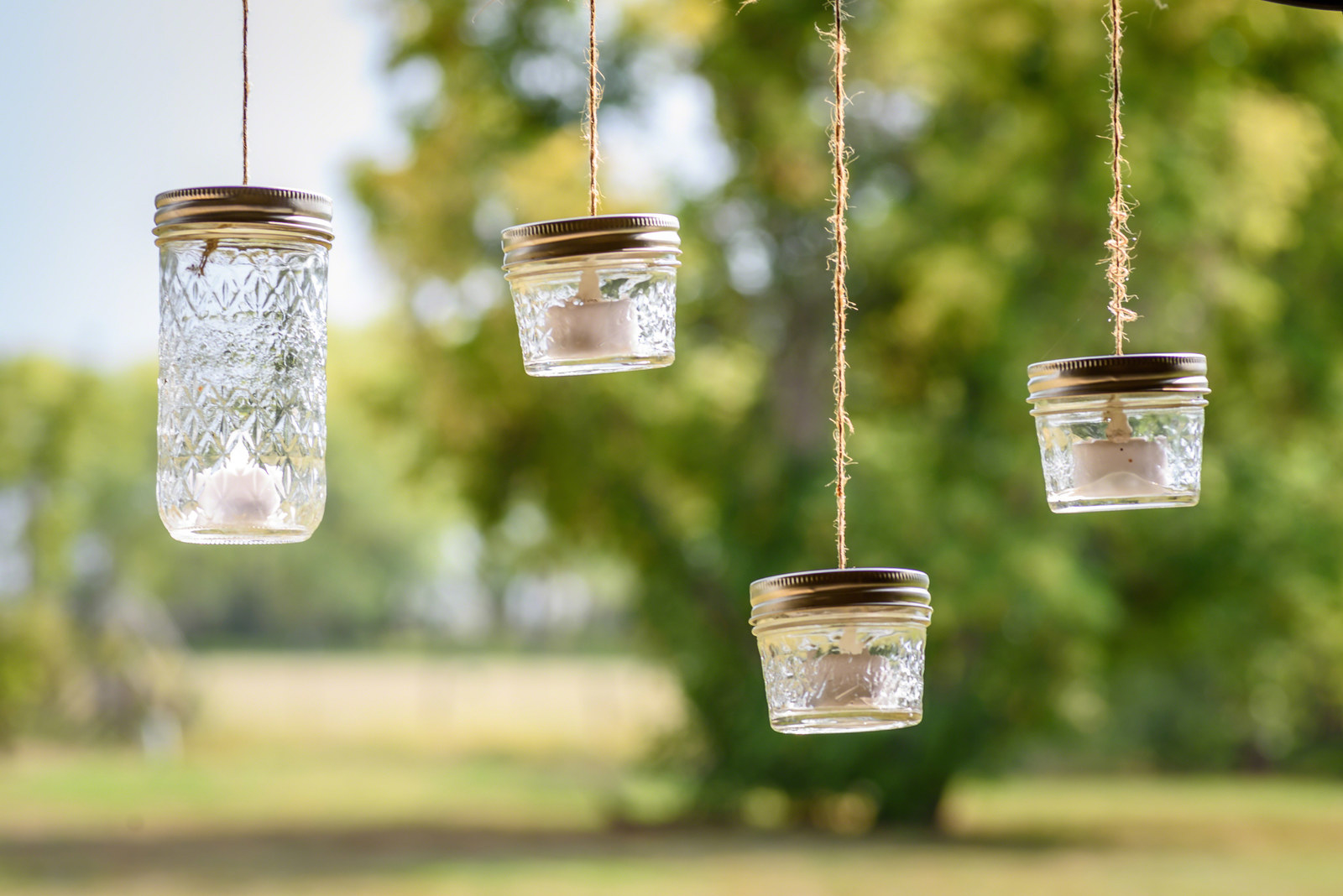 Mason jar candles hanging outdoors