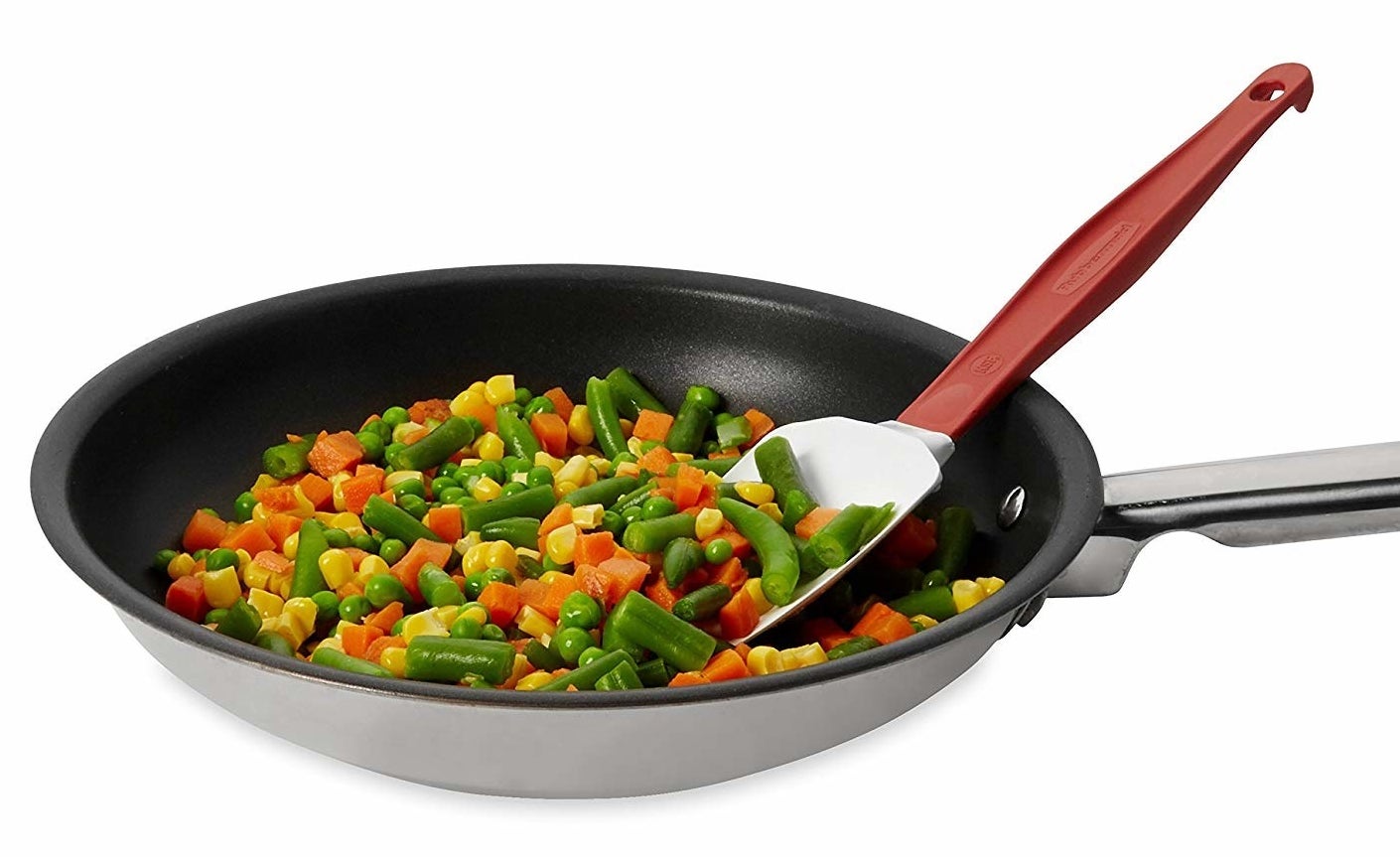 the silicone spoon spatula scooping mixed vegetables out of a pan
