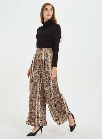 a model wearing the snake-print ankle-length pants