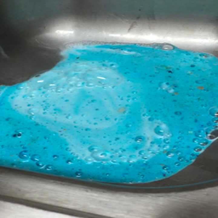 the sink filled with blue cleaner