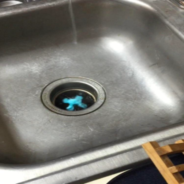 A reviewer's garbage disposal with blue cleaner starting to foam