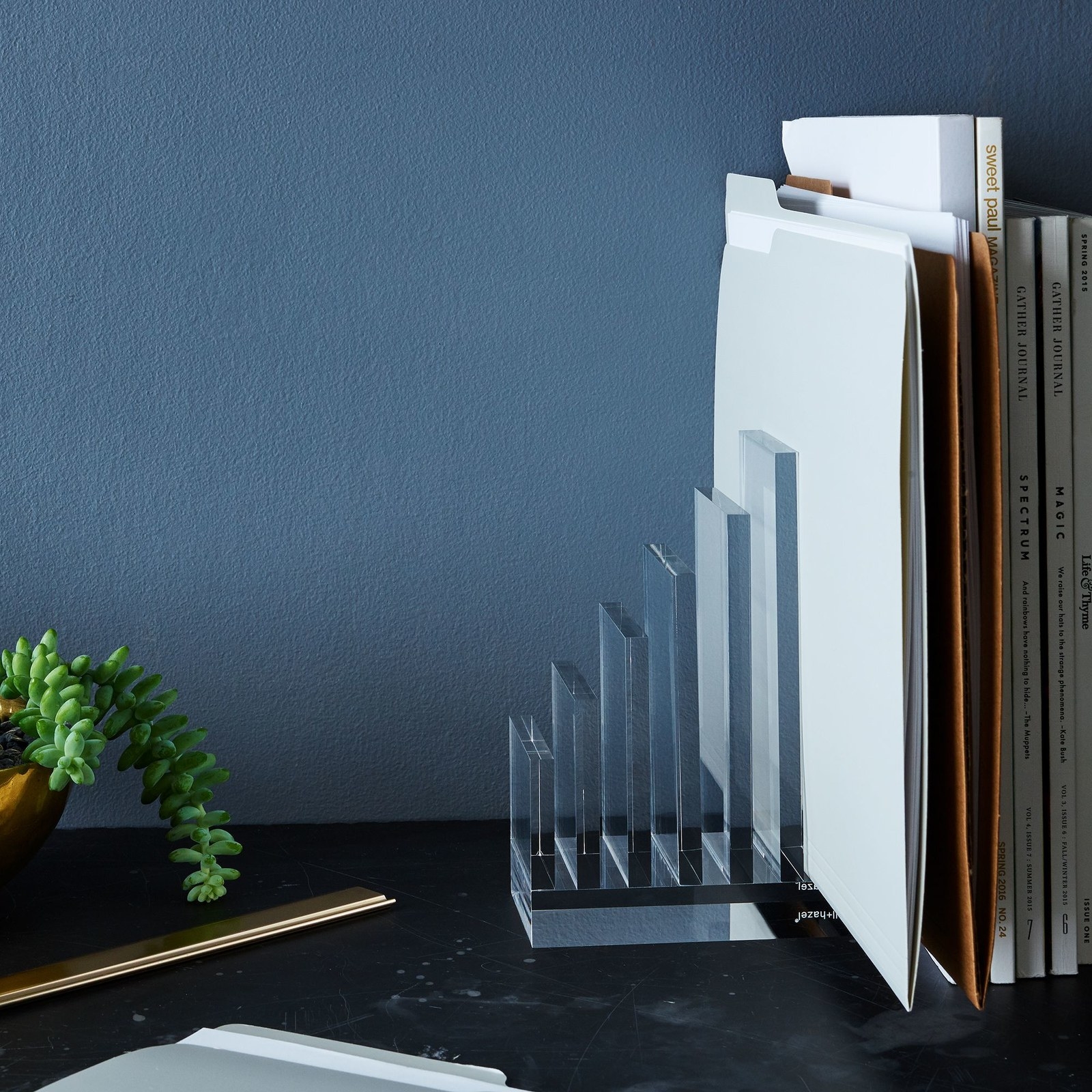 the acrylic bookends holding various files and magazines