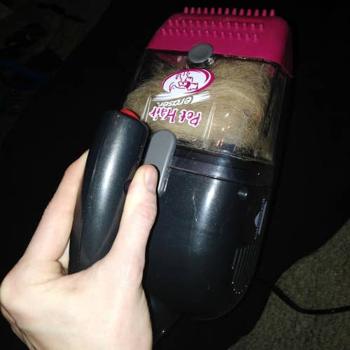small pet hair vacuum in someone's hand