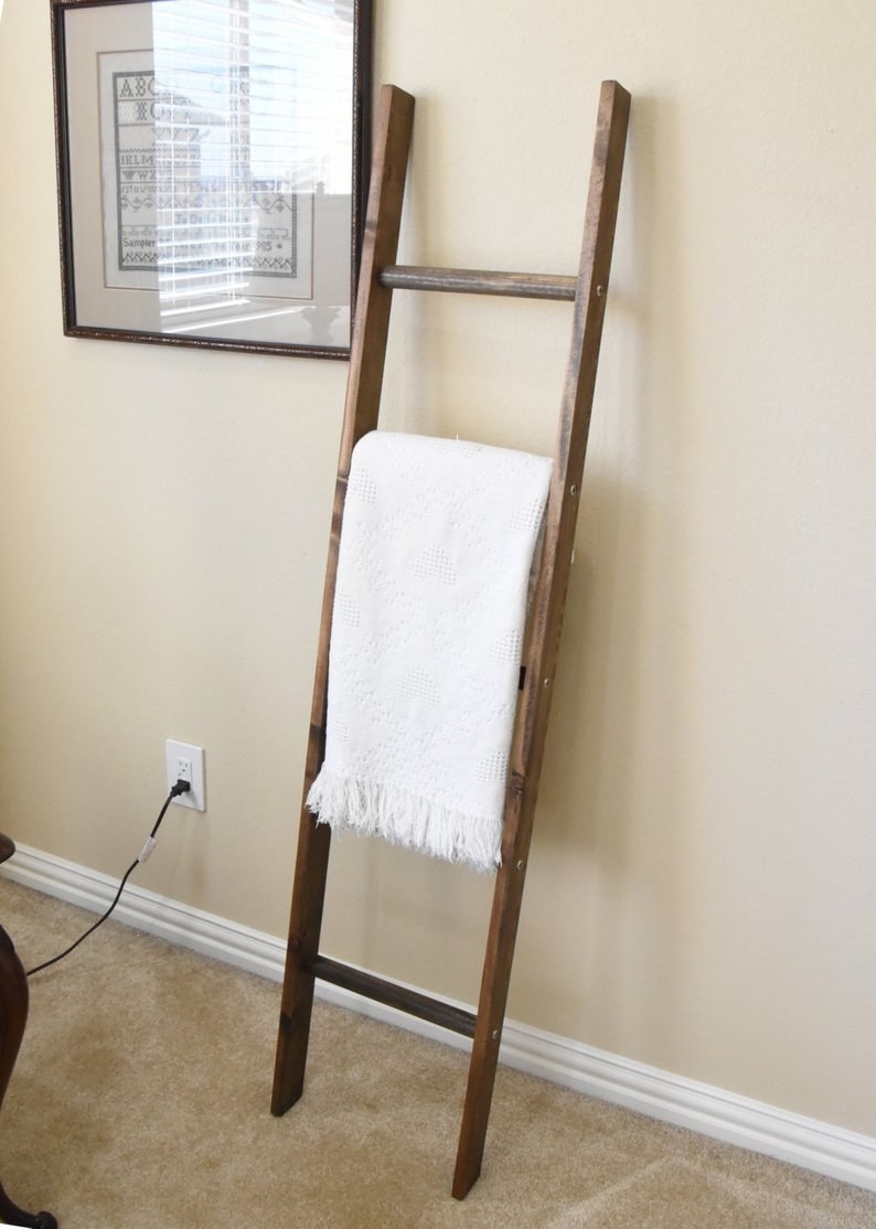 the five-foot ladder holding a white blanket
