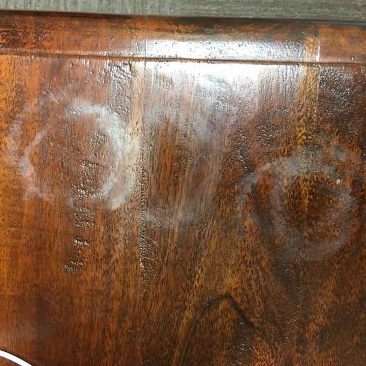wooden surface with circular watermarks on it from a cup or glass