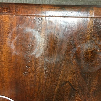 wooden surface with circular watermarks on it from a cup or glass
