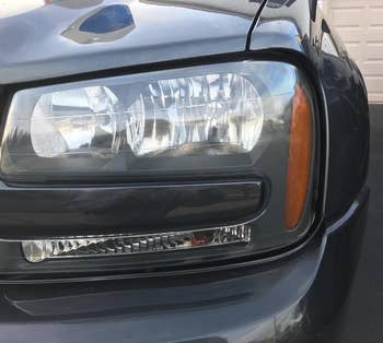 the same car headlight cleaned and clear