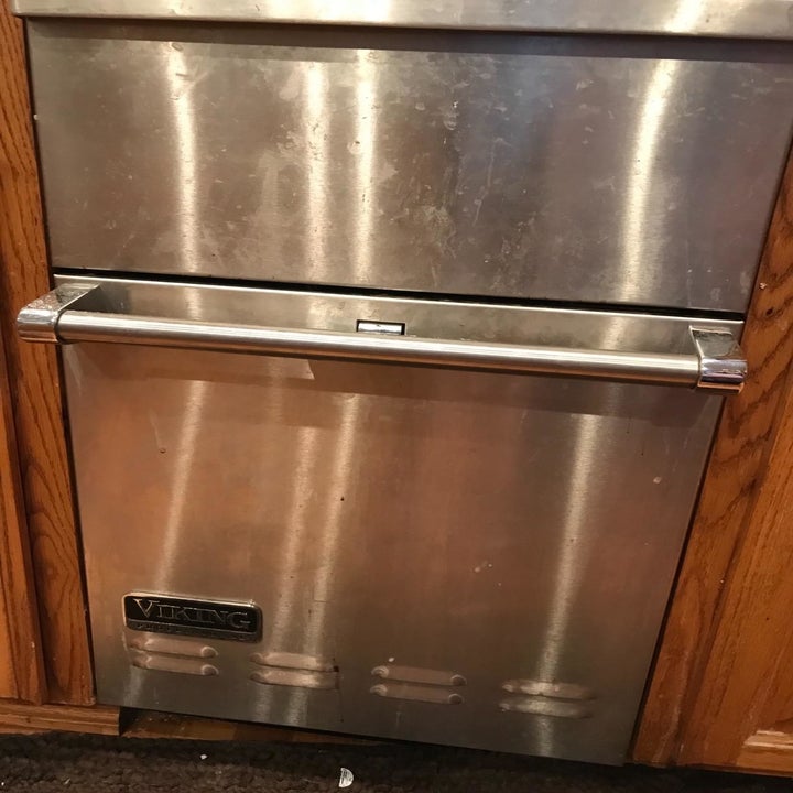 stainless steel dishwasher with some splatters and spots on it